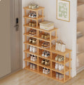Modern wooden shoe storage rack with multiple shelves, used to organize shoes in a small home entryway.